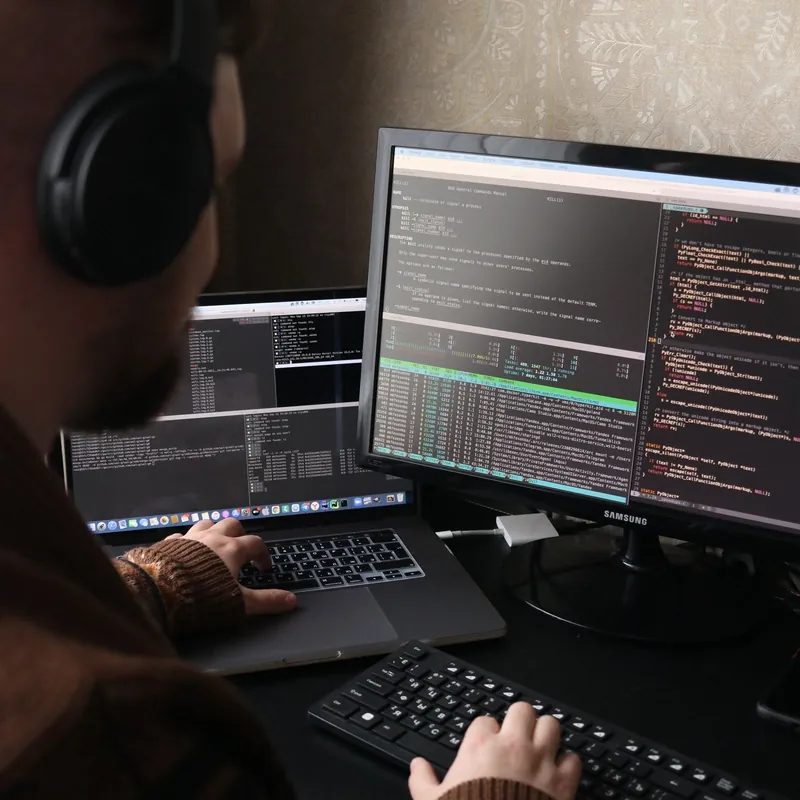 A developer working across two screens